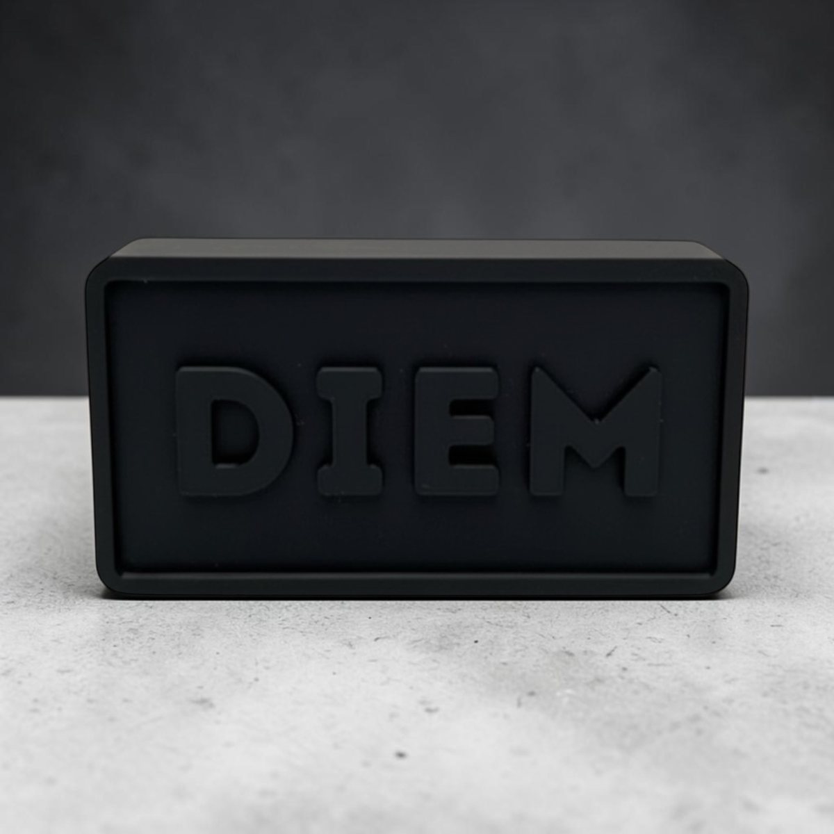 Black Diem Block on a counter with raised Diem lettering